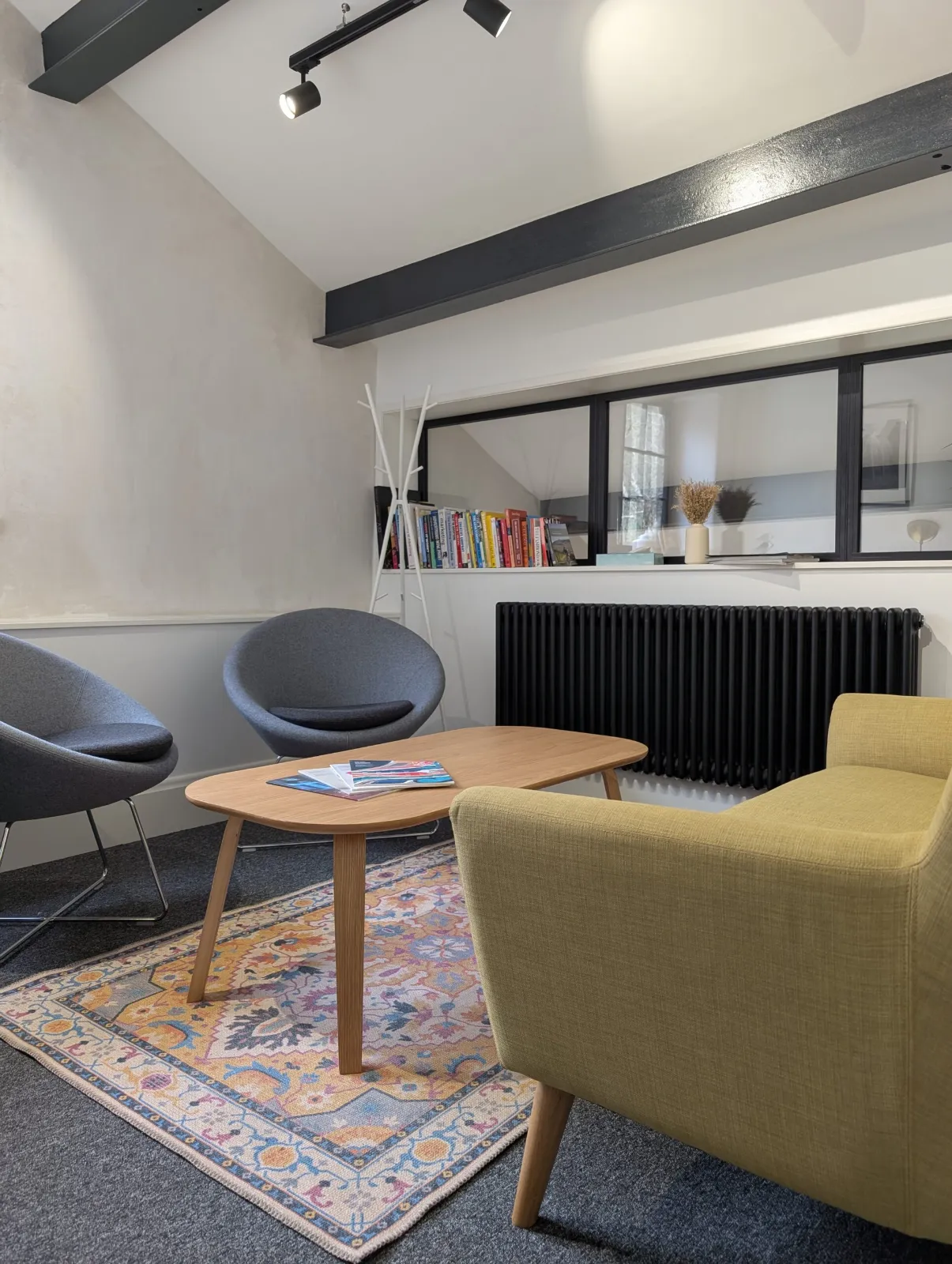 Nutclough therapy room at Spring Grove Stables, Hebden Bridge, with armchairs, sofa and coffee table