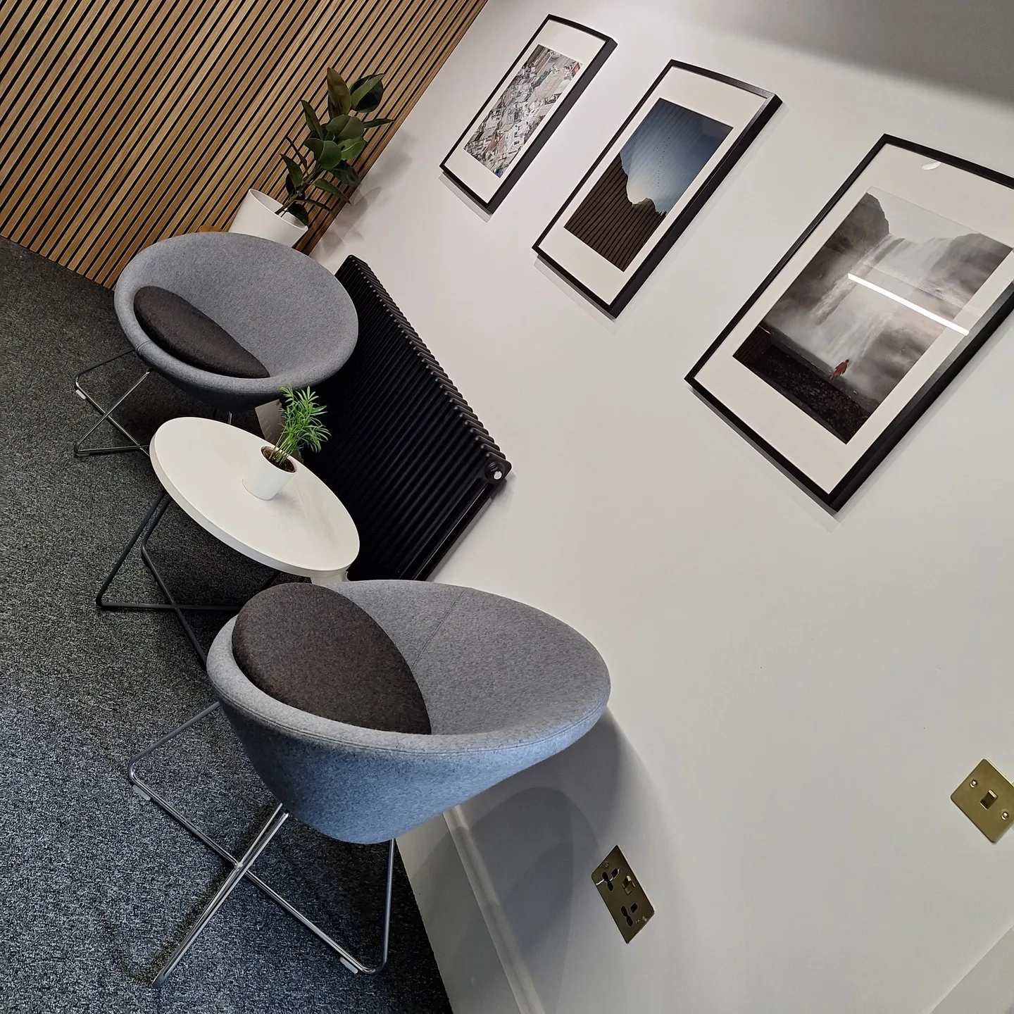 Armchairs and a side table set up in one of the meeting rooms
