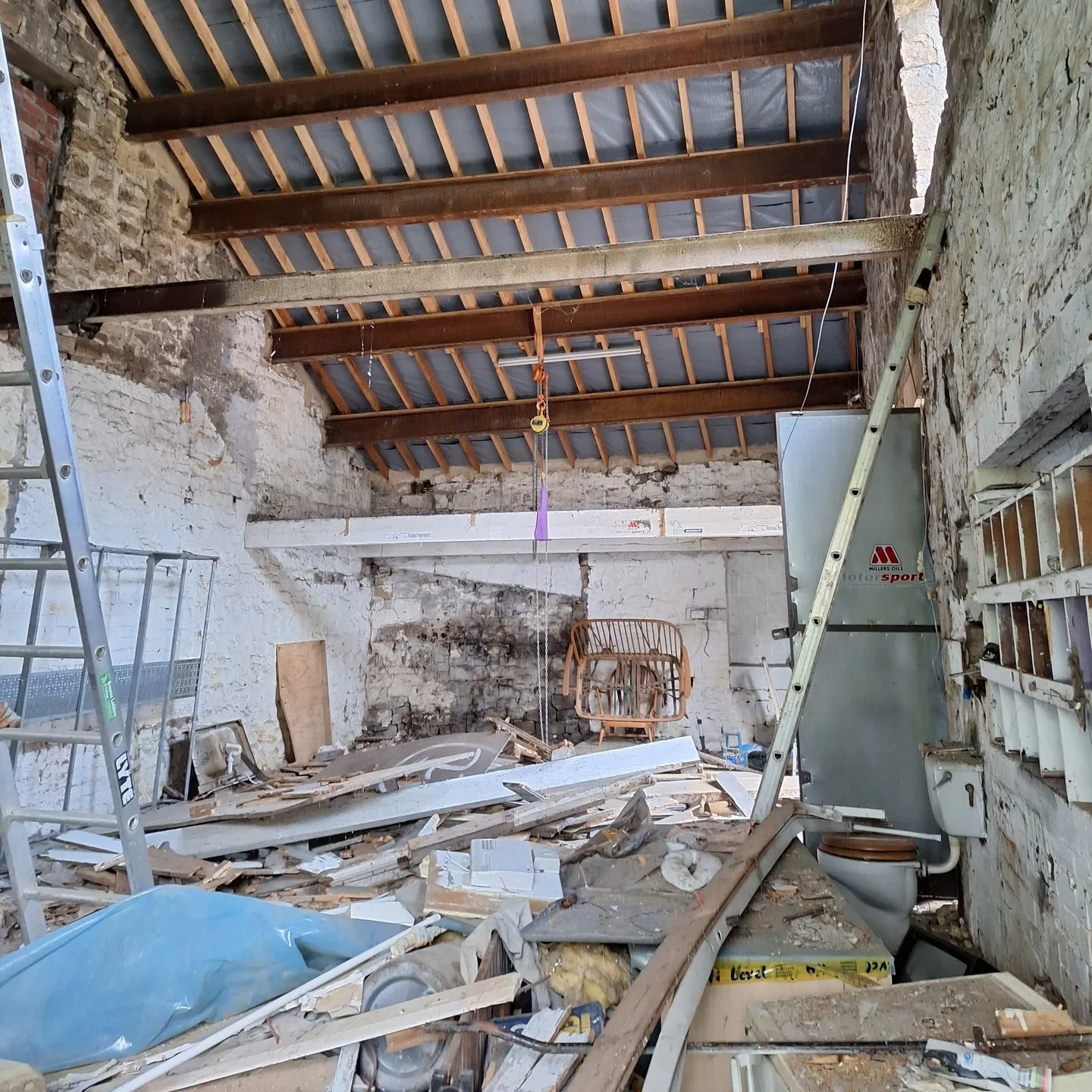 Rotten timber and rubble inside the stable during demolition