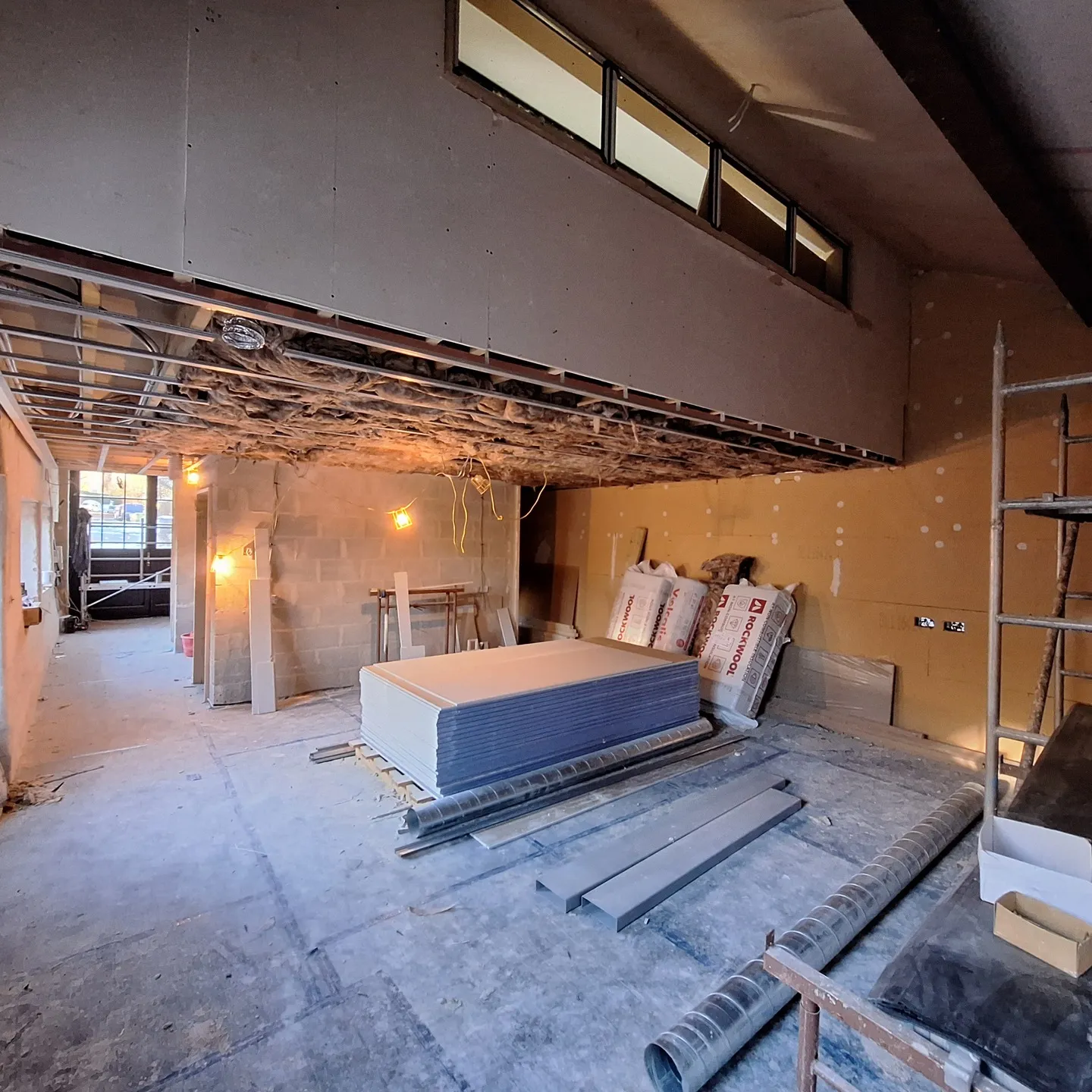 Walls and ceiling being double-boarded with plasterboard upstairs