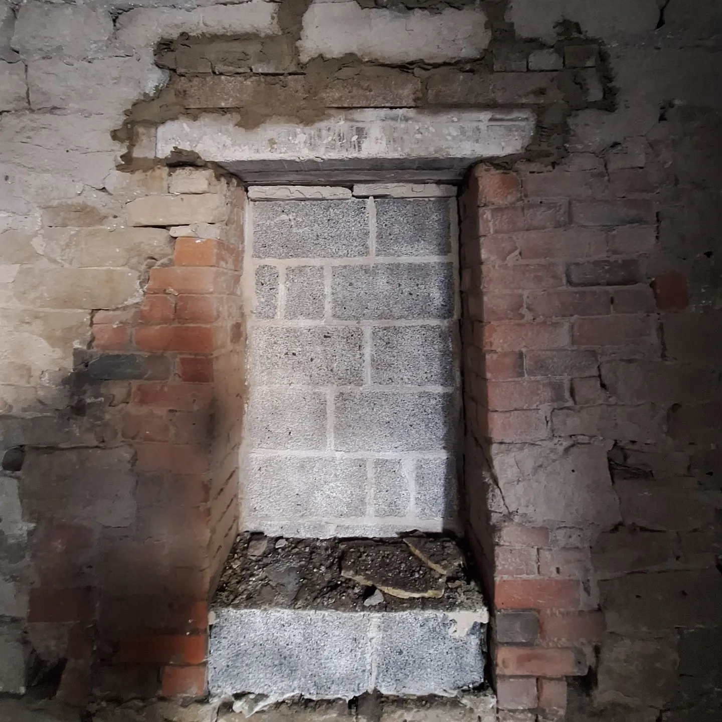 A blocked-up window opening being prepared for a new lintel