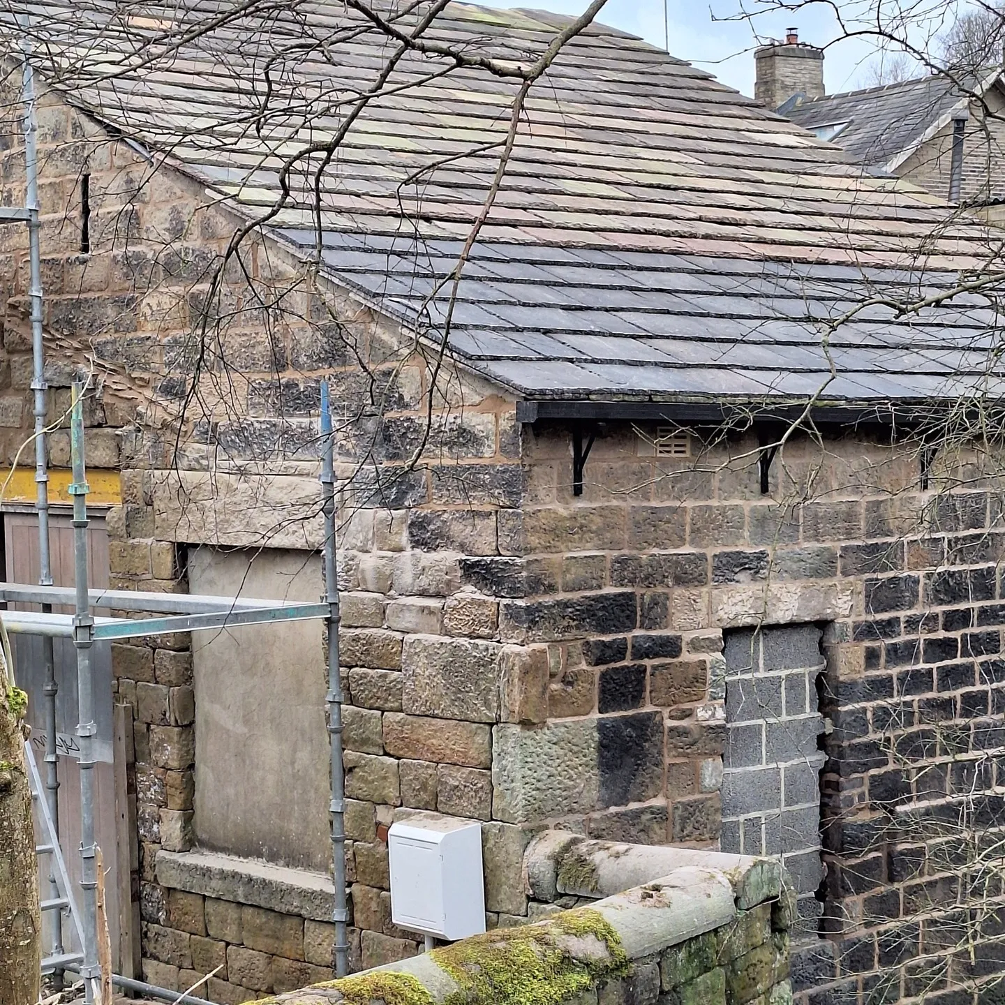 Scaffolding around the stable while the roof was stripped and re-slated