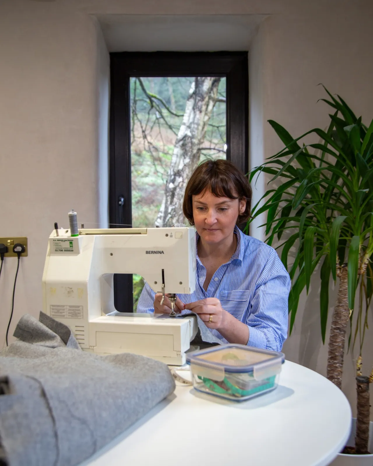 Natalie at a sewing machine during a Sew School evening