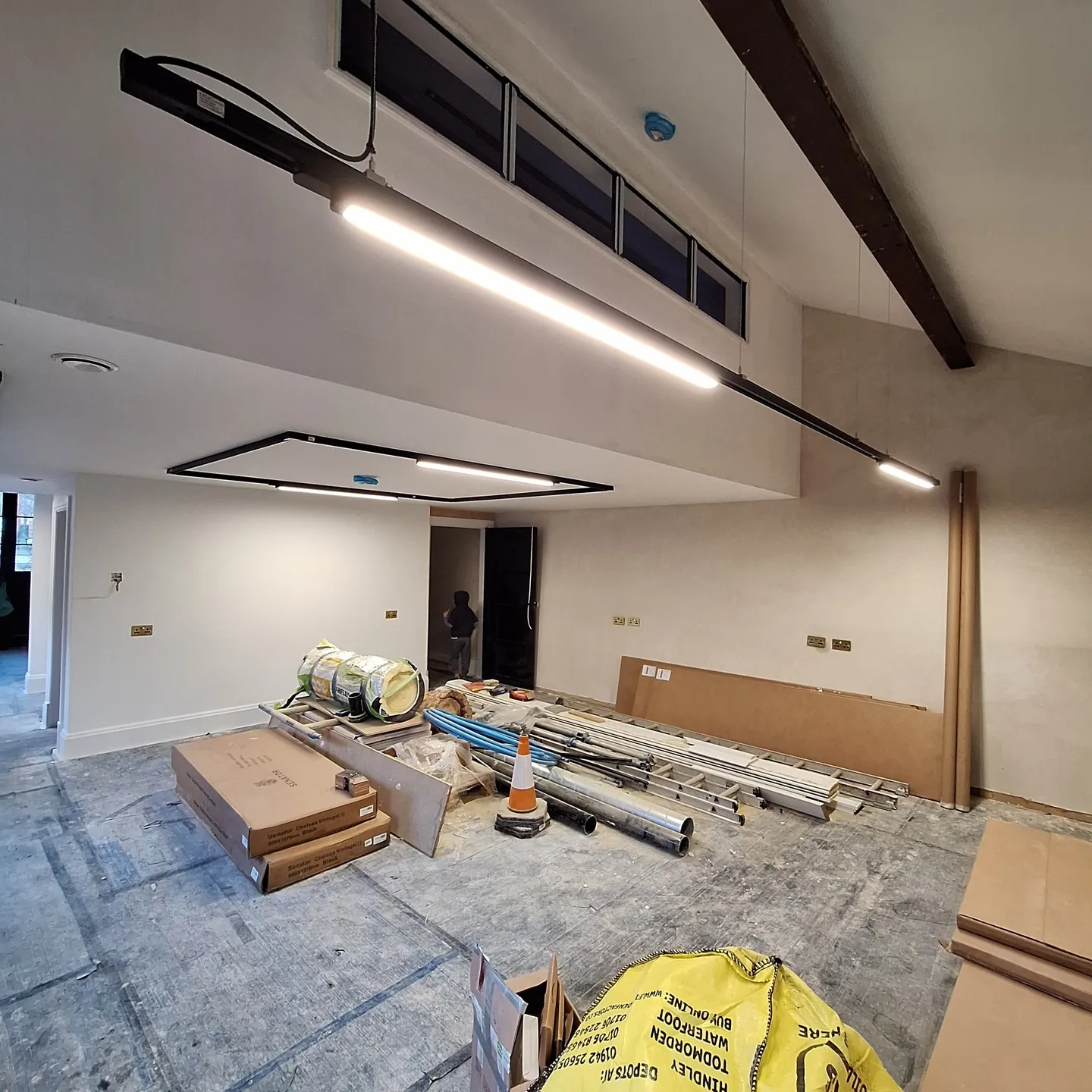 Three-circuit track lighting being installed in the main office